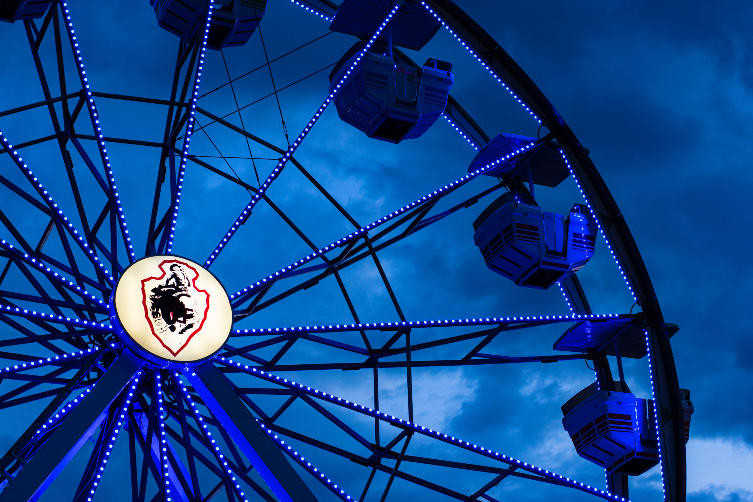 A photo of the Cheyenne Frontier Days ferris wheel with stormy clouds in the background.